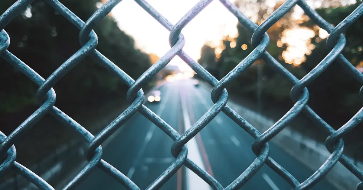 Close-up of a galvanised diamond mesh chain-link fence