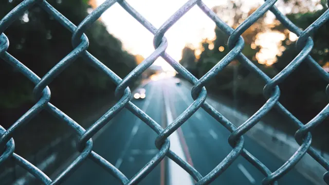Close-up of a galvanised diamond mesh chain-link fence