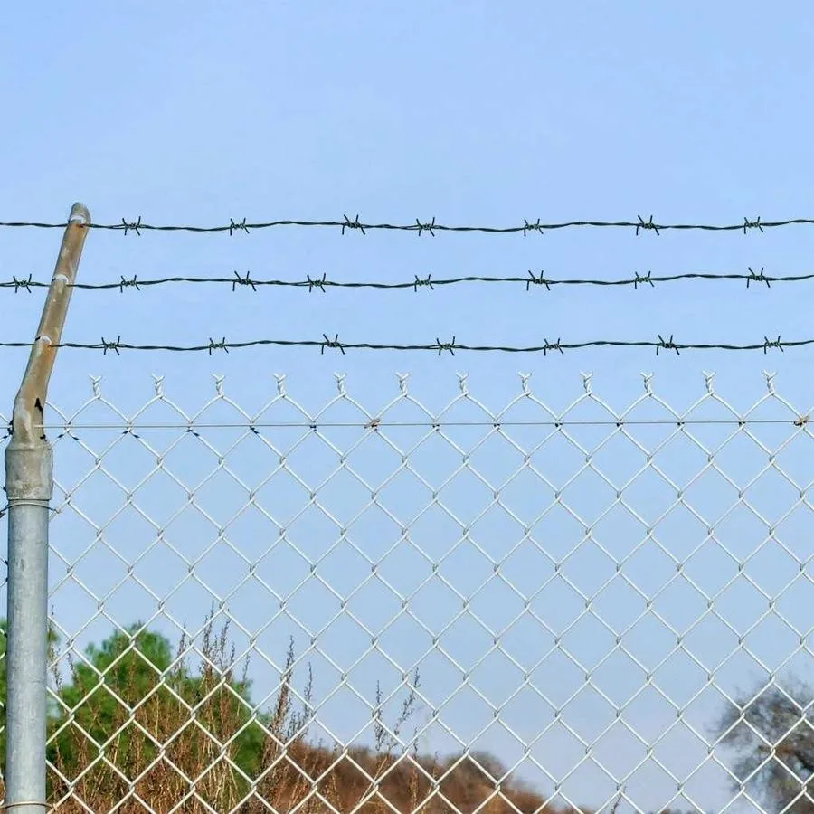 Barbed-wire strands installed above diamond mesh fencing