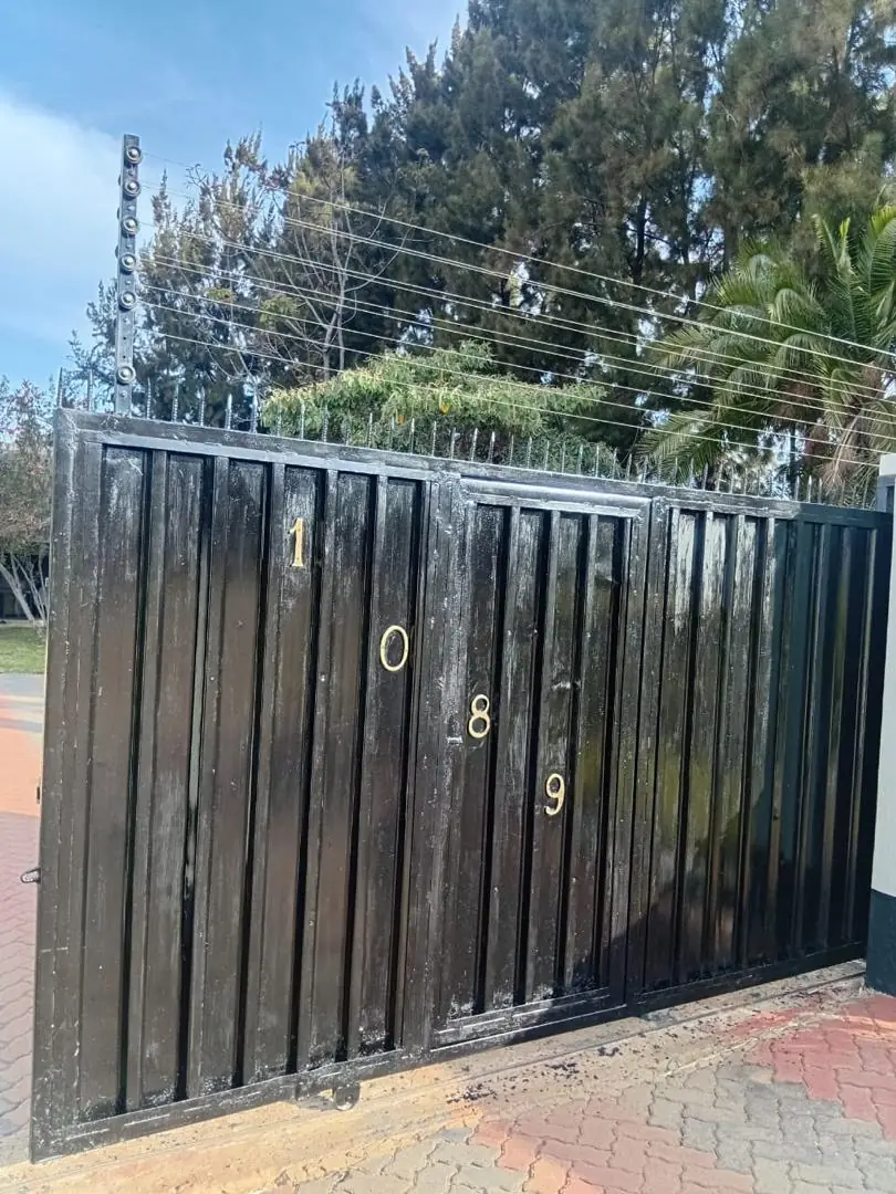 Azzar electric fence installed above a residential gate
