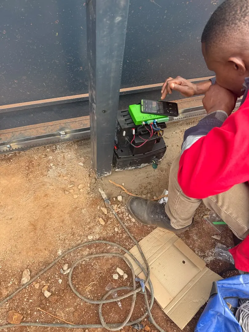 Azzar technician opening an electric gate motor via the smart app