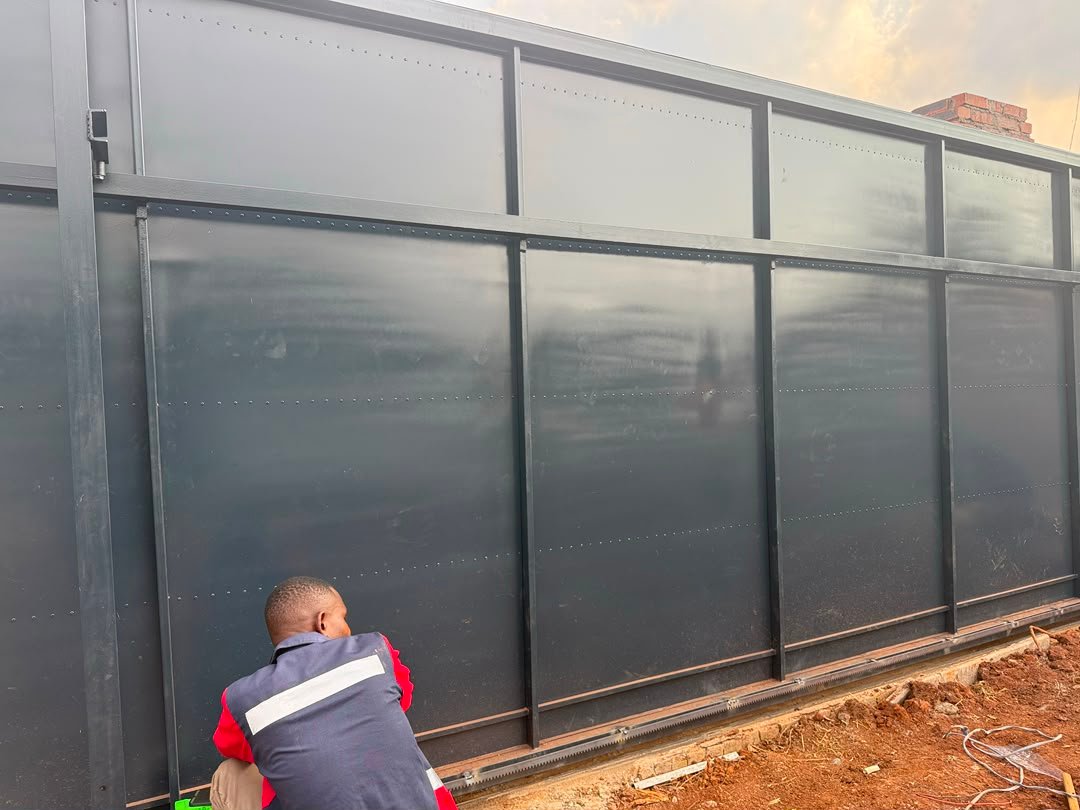 Azzar team installing an electric gate motor panel
